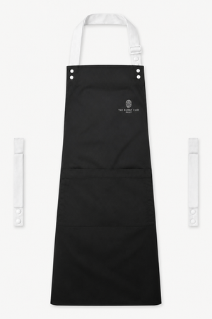 Black Swap & Pop apron with White straps, left chest logo